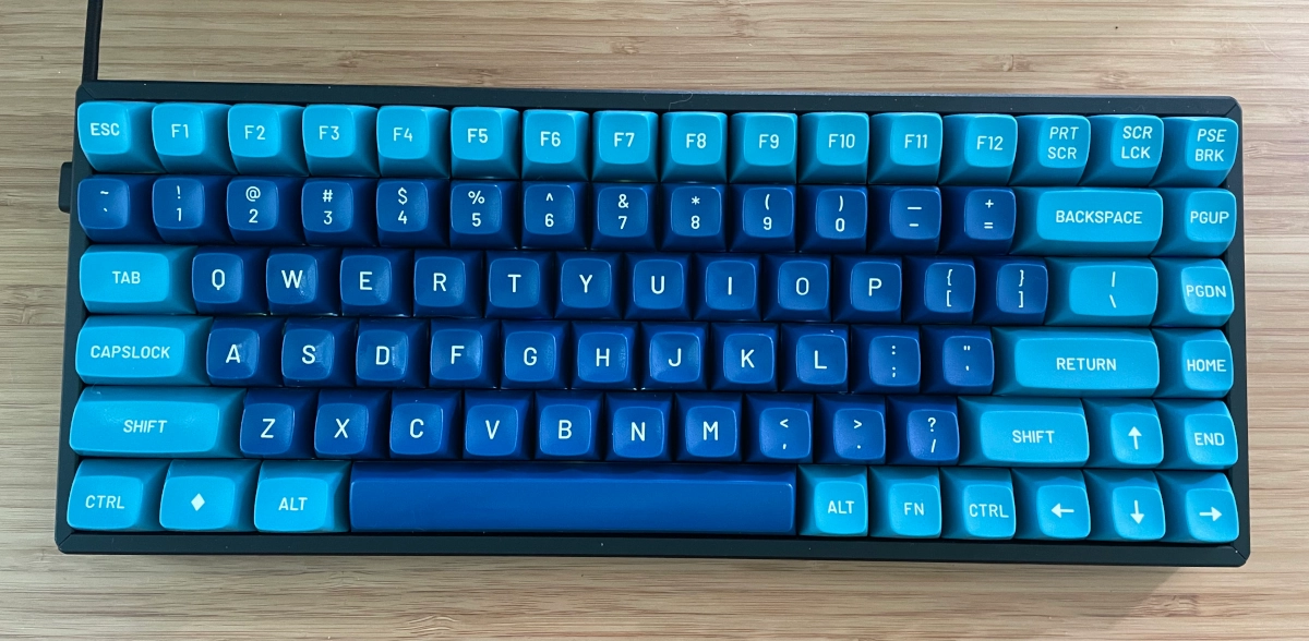 Top down view of keyboard with dark blue and light blue keycaps with white lettering
