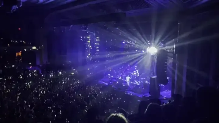 Disco Ball spinning in the Masonic Temple Theatre casting light on the audience and stage.