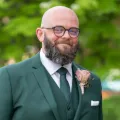 Photo of man in a green suit.